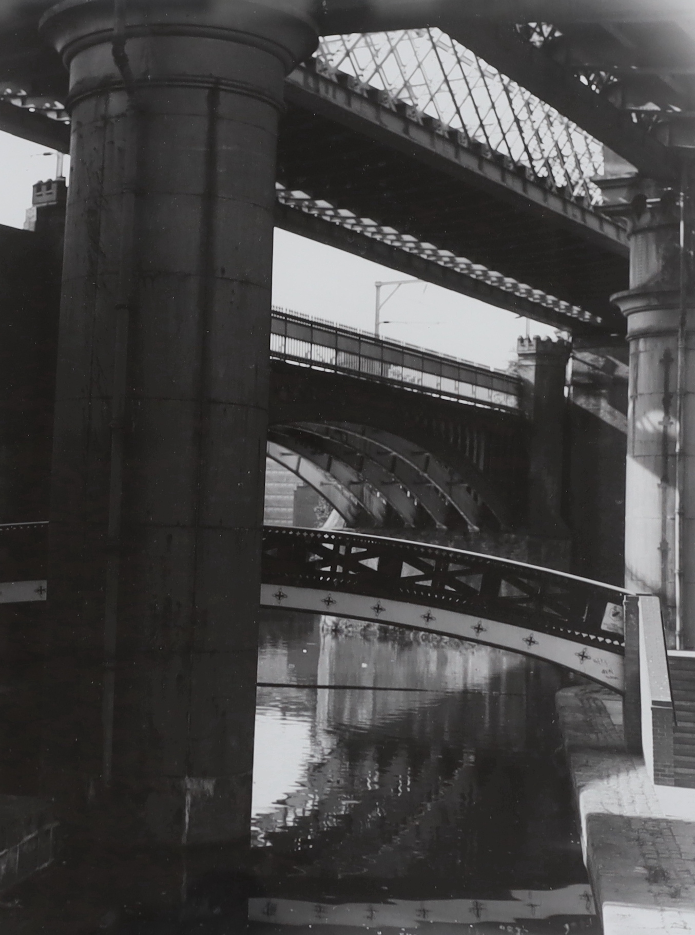 Two monochrome photographs, Manchester bridge views, 40 x 30cm